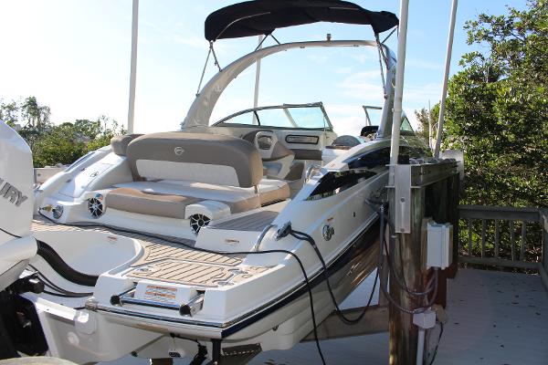 Crownline Eclipse E285 XS 2019 Crownline Eclipse E285 XS boat docked, featuring sleek design and spacious seating.