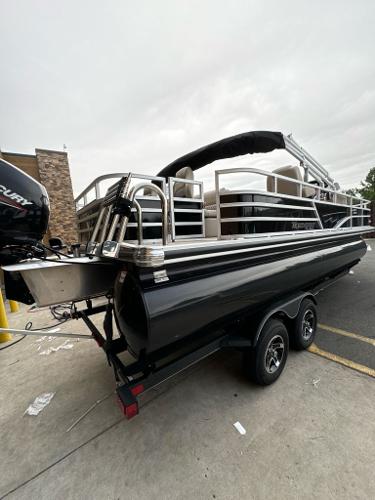 Ranger Reata 220F 2024 Ranger Reata 220F pontoon boat on trailer, featuring sleek design and modern amenities.