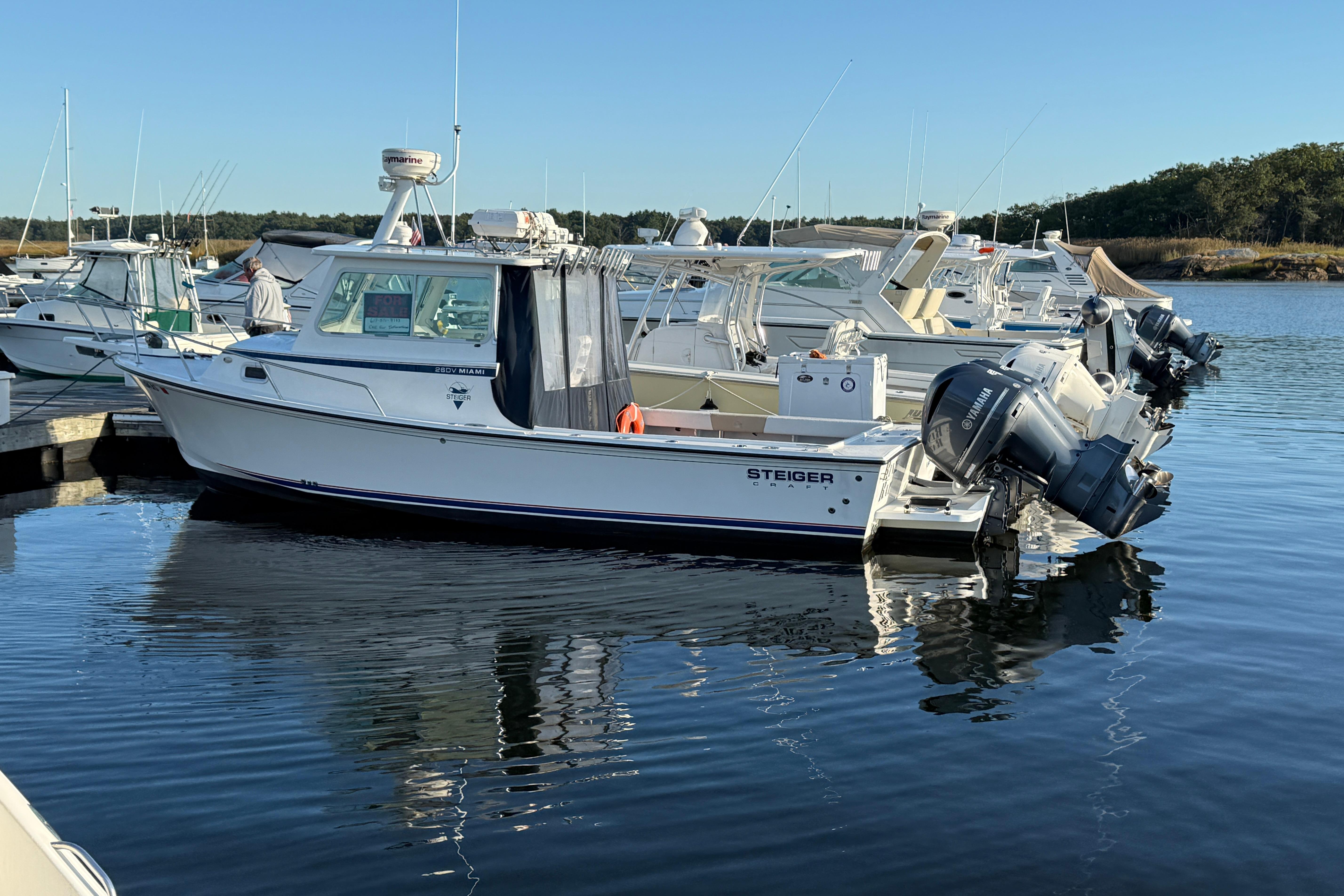Steiger Craft 26' Miami 2014 Steiger Craft 26' Miami boat docked in a marina, reflecting on calm water.