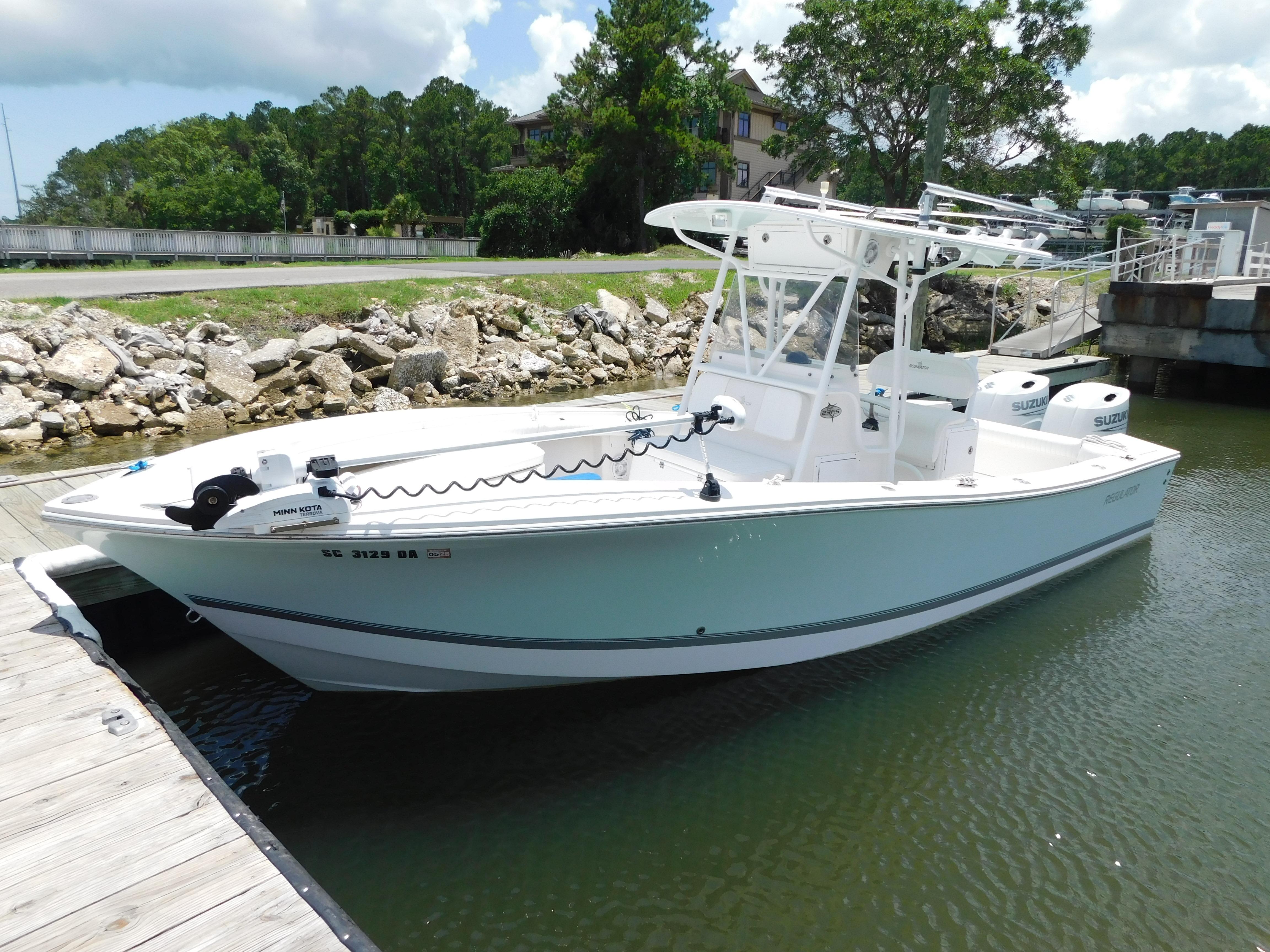 Regulator 23 Forward Seating 2008 Regulator 23 Forward Seating boat docked by a rocky shoreline.