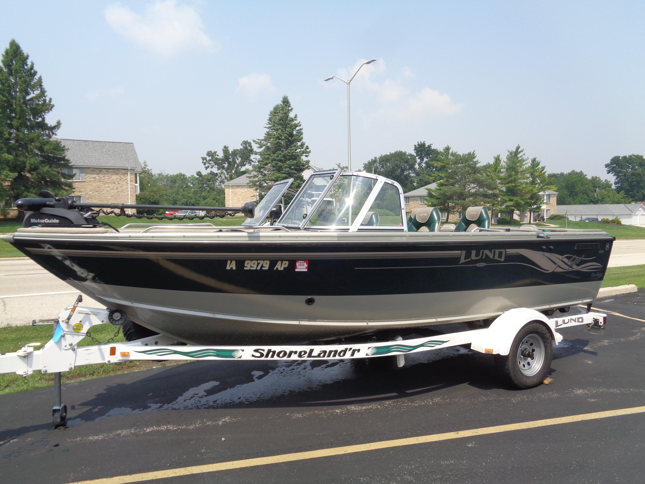 Lund 1850 Tyee GS ITS 2001 Lund 1850 Tyee GS ITS boat on ShoreLand'r trailer, parked outdoors.
