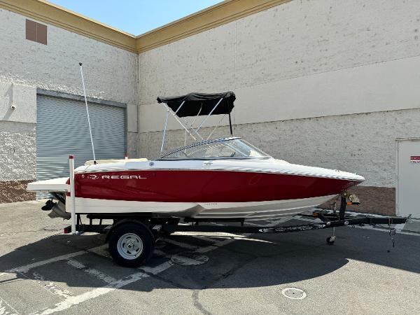 Regal 1900 ES Bowrider 2019 Regal 1900 ES Bowrider boat on a trailer in a parking lot.