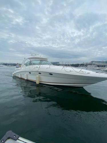 Sea Ray 420 Sundancer 2003 Sea Ray 420 Sundancer yacht on calm water under cloudy sky.