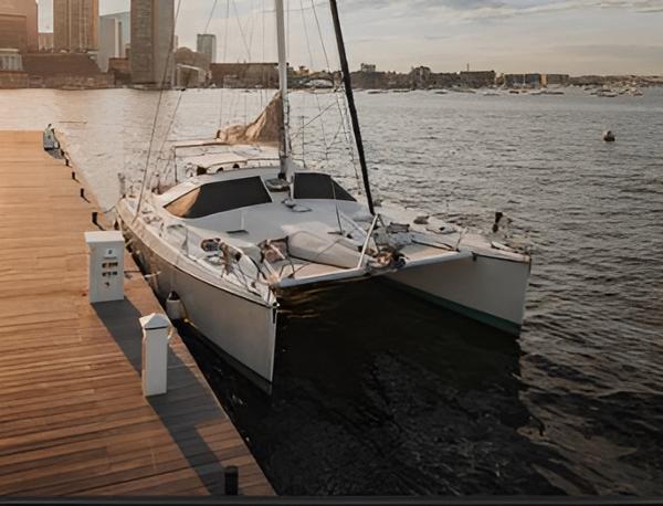 Privilege 43 Sailboat docked at marina, Privilege 43 model, 1993, with city skyline in background.