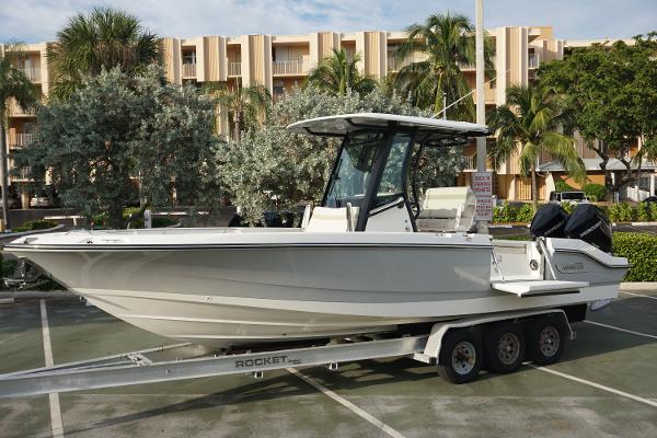 Boston Whaler 280 Dauntless 2024 Boston Whaler 280 Dauntless boat on trailer in parking lot.