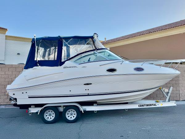 Sea Ray 240 Sundancer 2011 Sea Ray 240 Sundancer boat on trailer, side view, blue canopy.