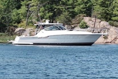 Tiara Yachts 3800 Open 2006 Tiara Yachts 3800 Open cruising on a serene lake with forested shoreline.