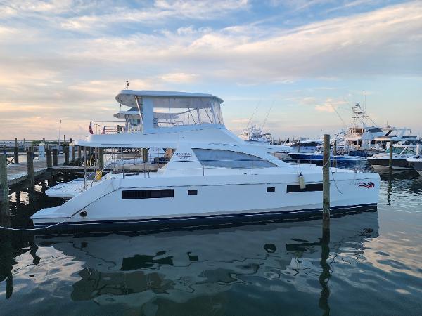 Leopard 51 Powercat 2019 Leopard 51 Powercat yacht docked at marina under a vibrant sky.