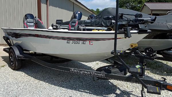 Ranger VS1665T 2022 Ranger VS1665T fishing boat on trailer, parked outdoors near a building.