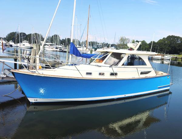 Legacy Yachts 32 2008 Legacy Yachts 32 in marina, featuring a sleek blue hull and classic design.