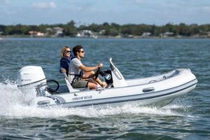 Highfield Classic 360 GT 2024 Highfield Classic 360 GT boat cruising on a sunny day with two passengers.