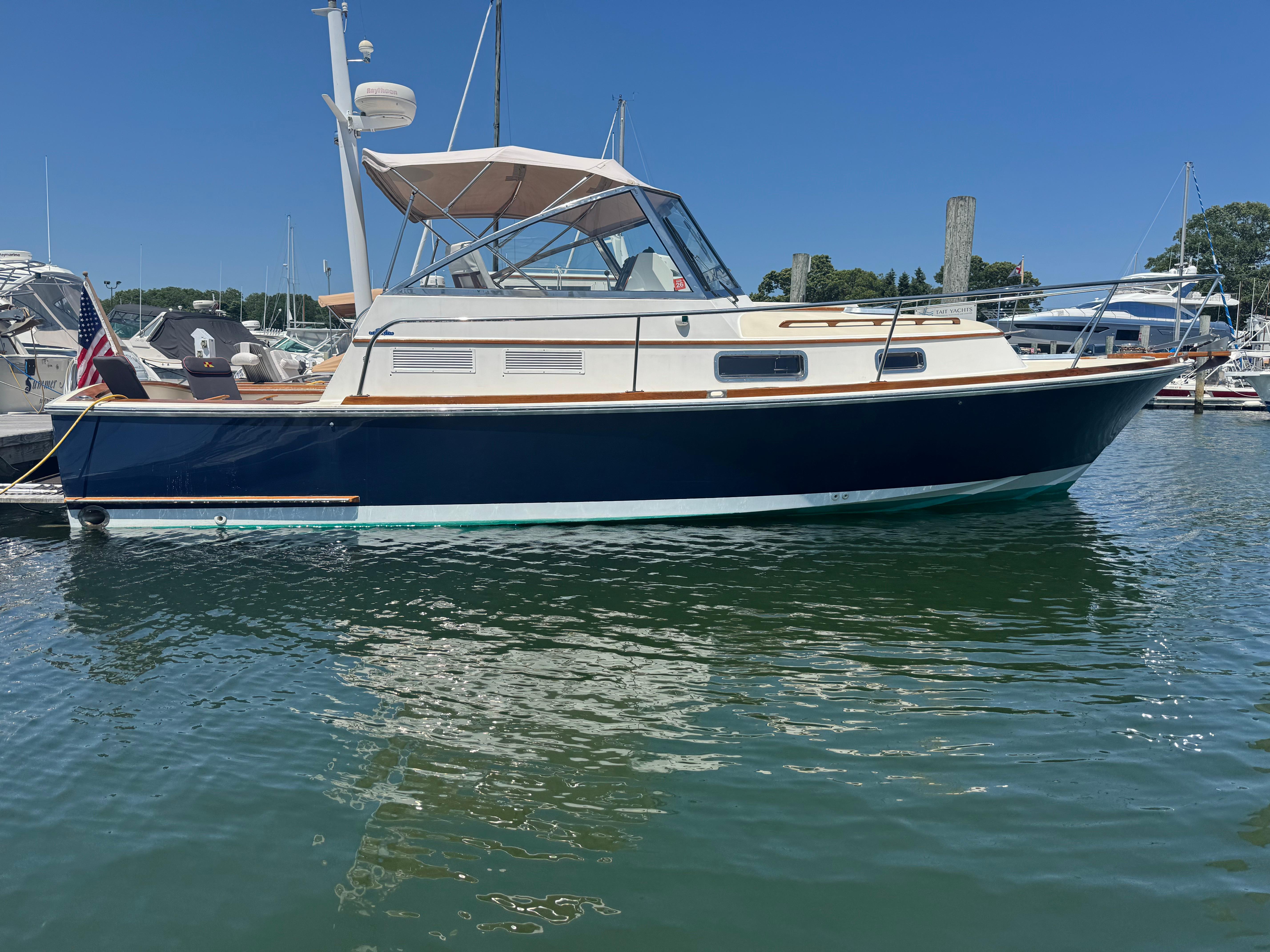 Bruckmann Bluestar 29.9 Bruckmann Bluestar 29.9 boat, 2000 model, docked in a marina under clear blue sky.