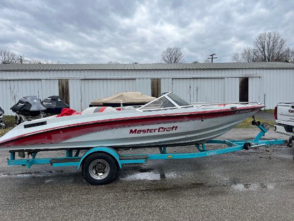 MasterCraft Tristar 220 1991 MasterCraft Tristar 220 boat on trailer, parked outdoors, overcast sky.