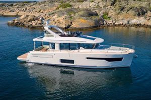 Nimbus 495 Flybridge Nimbus 495 Flybridge 2025 yacht cruising near rocky shoreline.