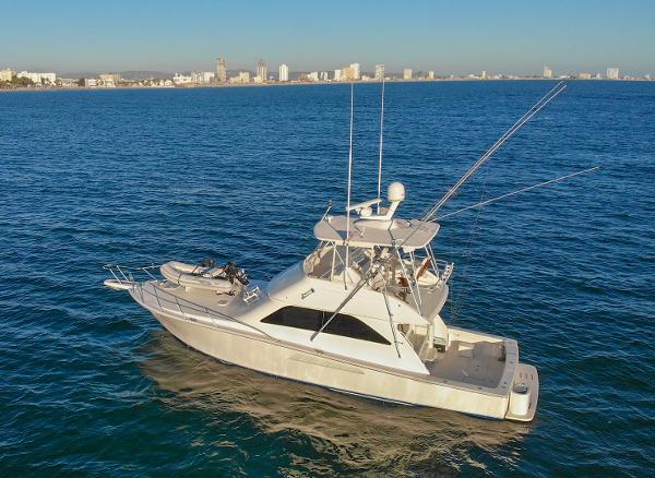 Viking 45 Convertible 2007 Viking 45 Convertible yacht on open water with city skyline in background.