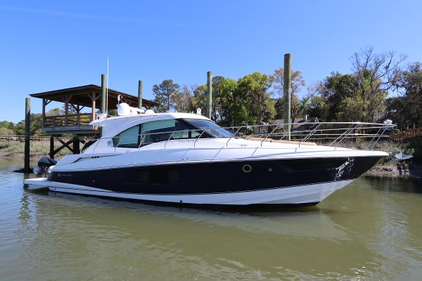 Cruisers Yachts Cantius 450 2015 Cruisers Cantius yacht docked on calm water under clear blue sky.
