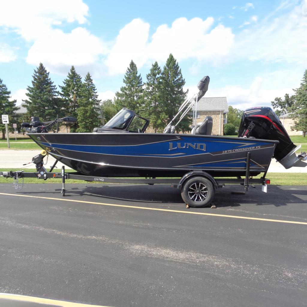 Lund 1875 Crossover XS 2026 Lund 1875 Crossover XS boat on trailer, parked outdoors, sunny day.