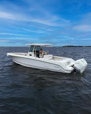 Boston Whaler 330 Outrage 2021 Boston Whaler 330 Outrage boat on open water under a clear blue sky.