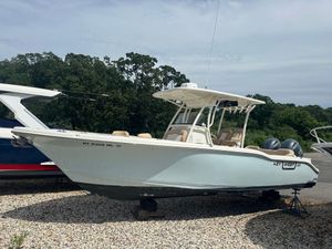 Key West 263 FS 2019 Key West 263 FS boat on gravel, surrounded by trees and other boats.