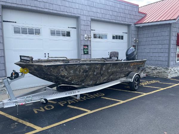Excel 1751 River Warrior 2025 Excel 1751 River Warrior boat on trailer, parked in front of garage.