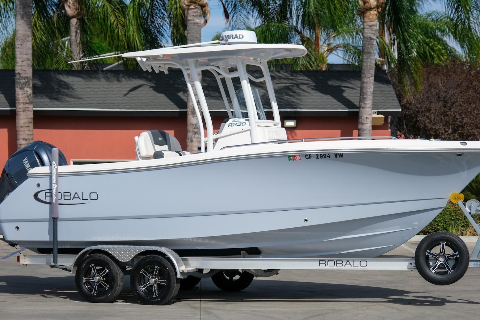 Robalo R230 Center Console 2023 Robalo R230 Center Console boat on trailer, parked outdoors.