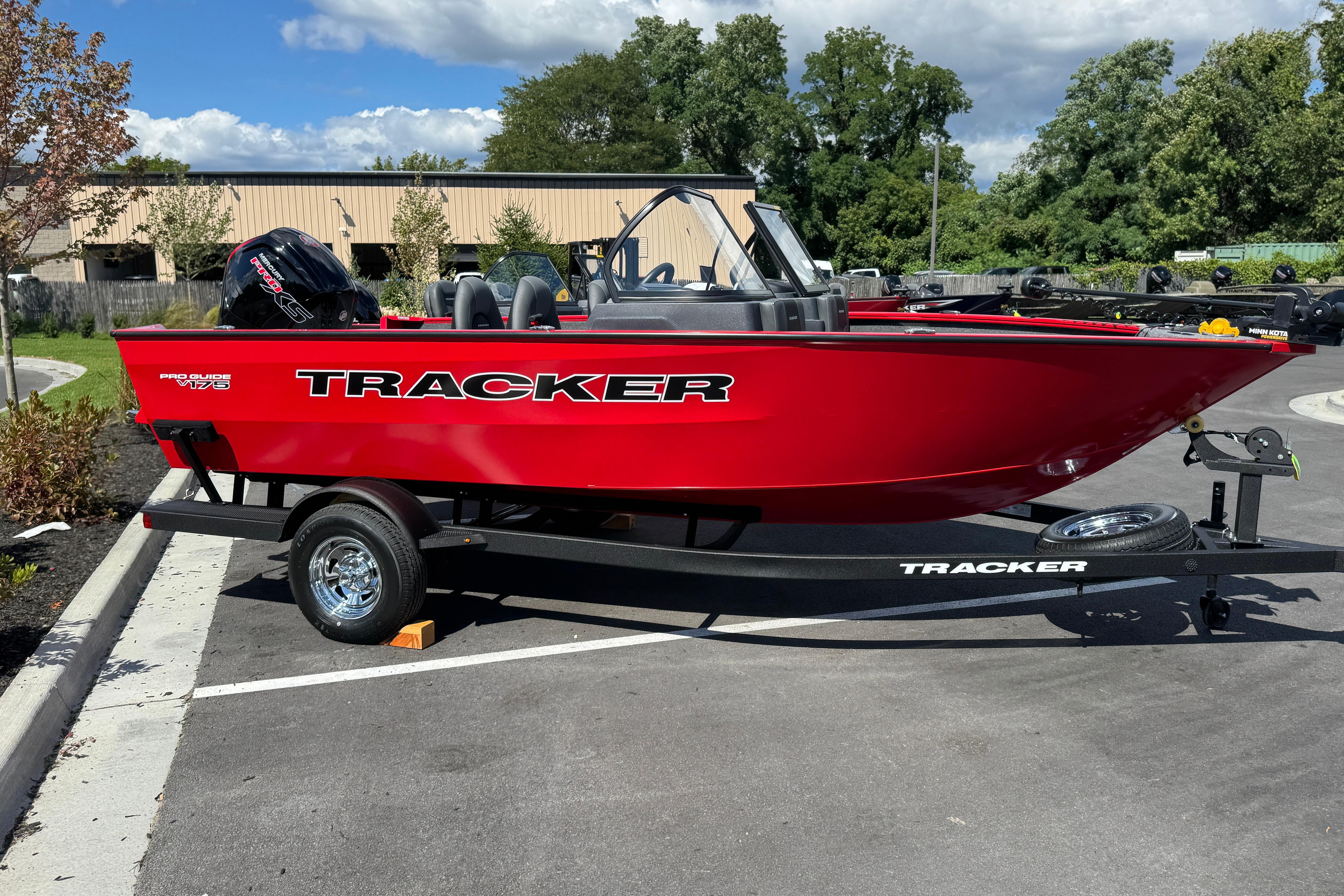 Tracker Pro Guide V-175 WT Red 2026 Tracker Pro Guide V-175 WT boat on trailer in parking lot.