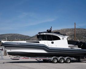 Rafnar 1200 Cross Cabin 2023 Rafnar 1200 Cross Cabin boat on trailer, parked outdoors under clear blue sky.