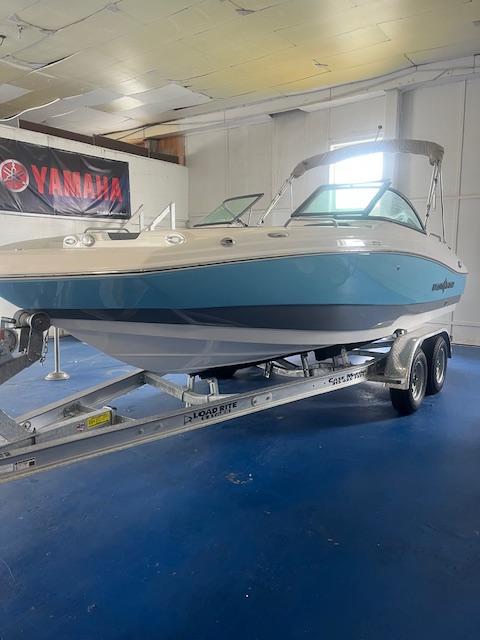 NauticStar 203 DC 2025 NauticStar 203 DC boat on trailer in showroom with Yamaha banner.