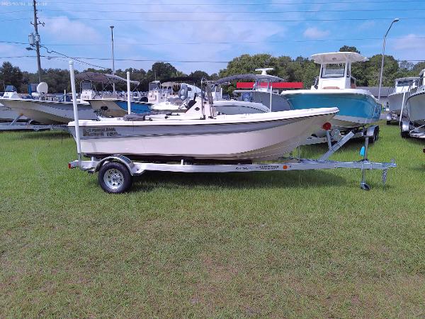 Carolina Skiff 162 JLS 2023 Carolina Skiff 162 JLS boat on a trailer, displayed on grass.