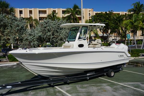 Boston Whaler 250 Outrage 2024 Boston Whaler 250 Outrage boat on trailer in parking lot.