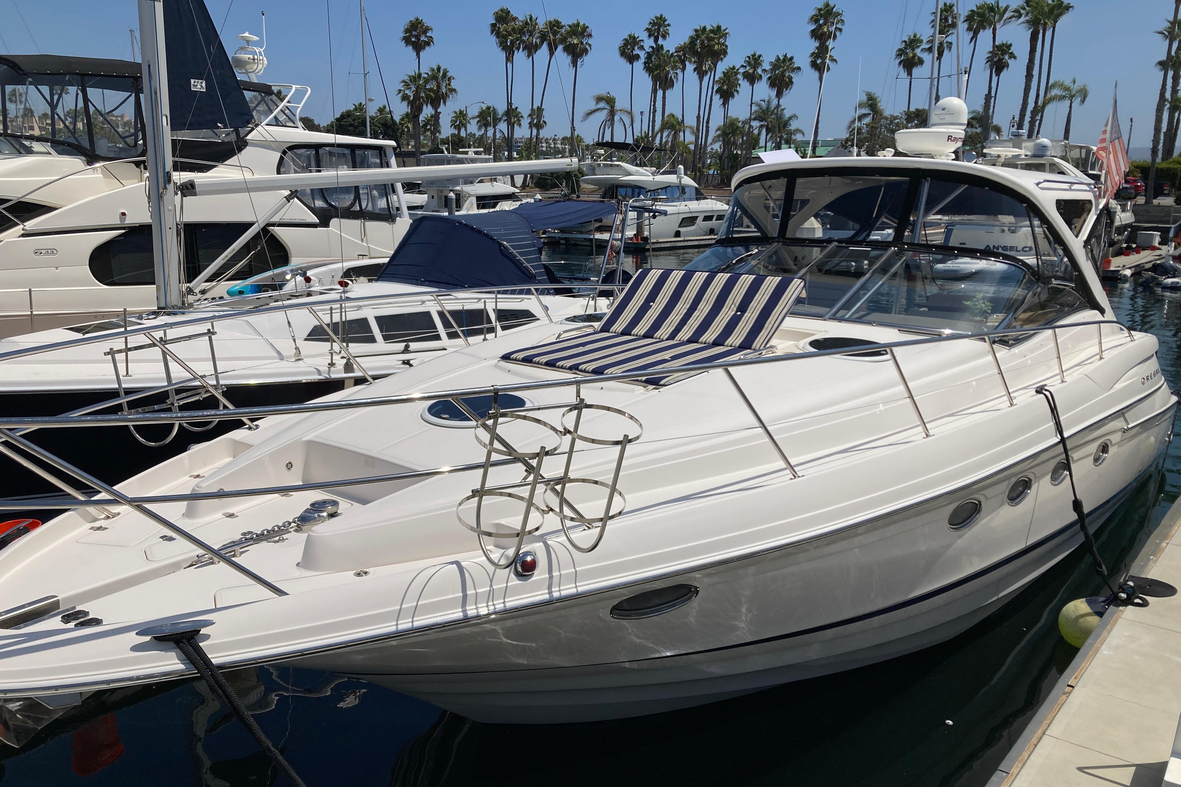 Regal Commodore 4460 2010 Regal 4460 Monterrey yacht docked at marina with palm trees in background.