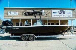 Caymas 281 HB 2025 Caymas 281 HB boat on trailer outside a store, showcasing sleek design.
