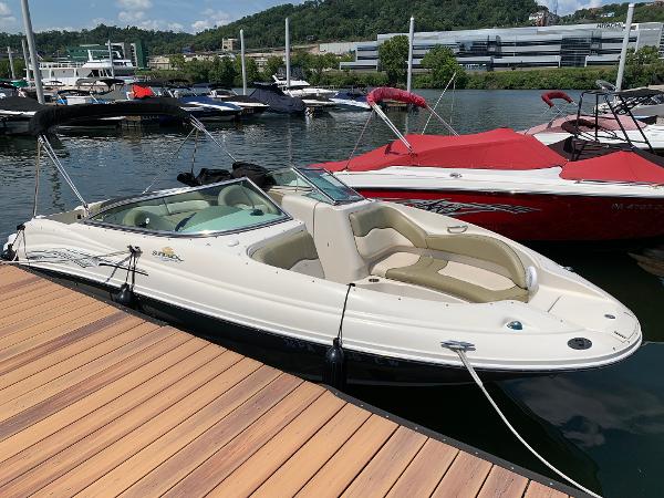 Sea Ray 220 Sundeck 2005 Sea Ray 220 Sundeck boat docked at a marina, surrounded by other boats.