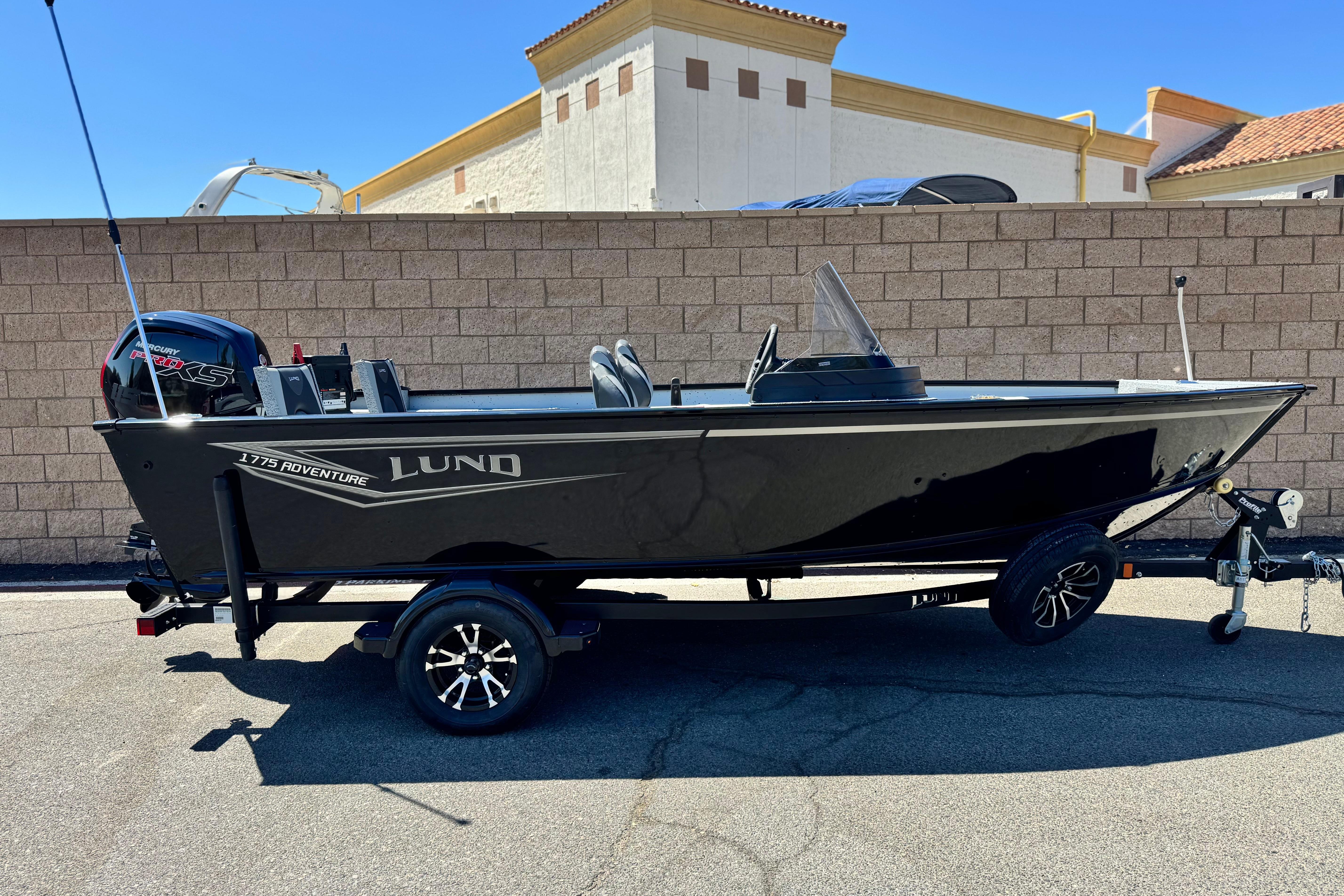 Lund 1775 Adventure Sport 2024 Lund 1775 Adventure Sport boat on trailer, parked outdoors.