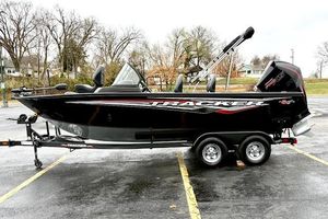 Tracker Targa V-19 WT 2024 Tracker Targa V-19 WT boat on trailer, parked outdoors, side view.