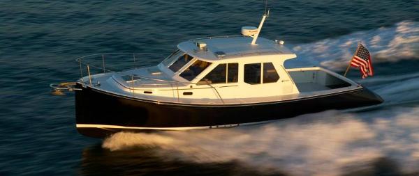 True North 38 True North Pearson 38 True North 2010 yacht cruising on open water with American flag.