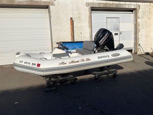 Brig F330HT 2016 Brig F330HT inflatable boat with Mercury engine, parked outside garage.
