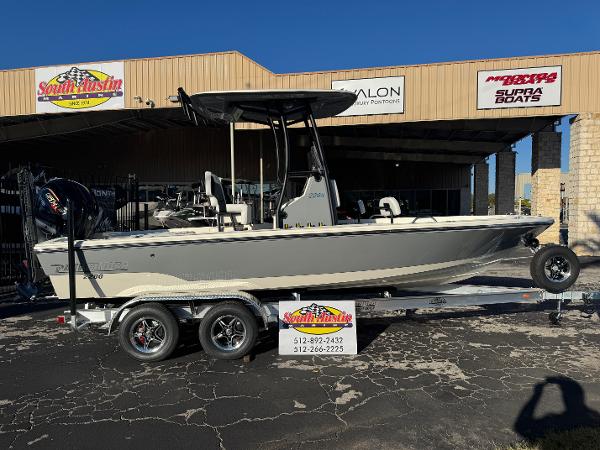 Pathfinder 2200 TRS 2025 Pathfinder 2200 TRS boat on trailer at dealership, side view.