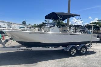 Boston Whaler 210 Montauk 2024 Boston Whaler 210 Montauk boat on trailer, featuring a sleek design and canopy.