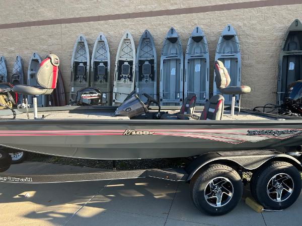 Ranger RT188P 2025 Ranger RT188P boat with dual seats, displayed outdoors, surrounded by kayaks.