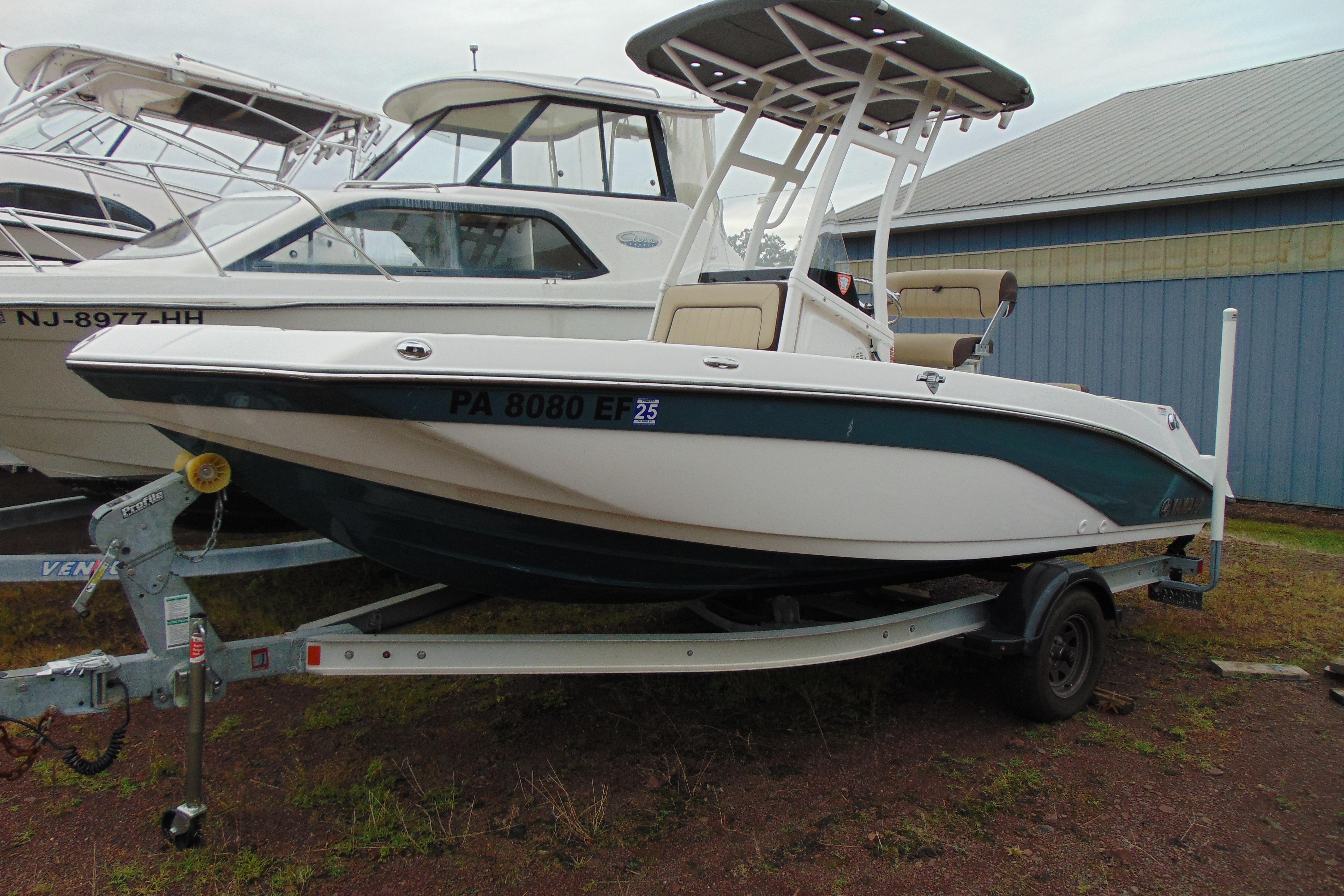 Yamaha Boats 195 FSH Sport 2021 Yamaha 195 FSH Sport boat on trailer, parked outdoors near other boats.