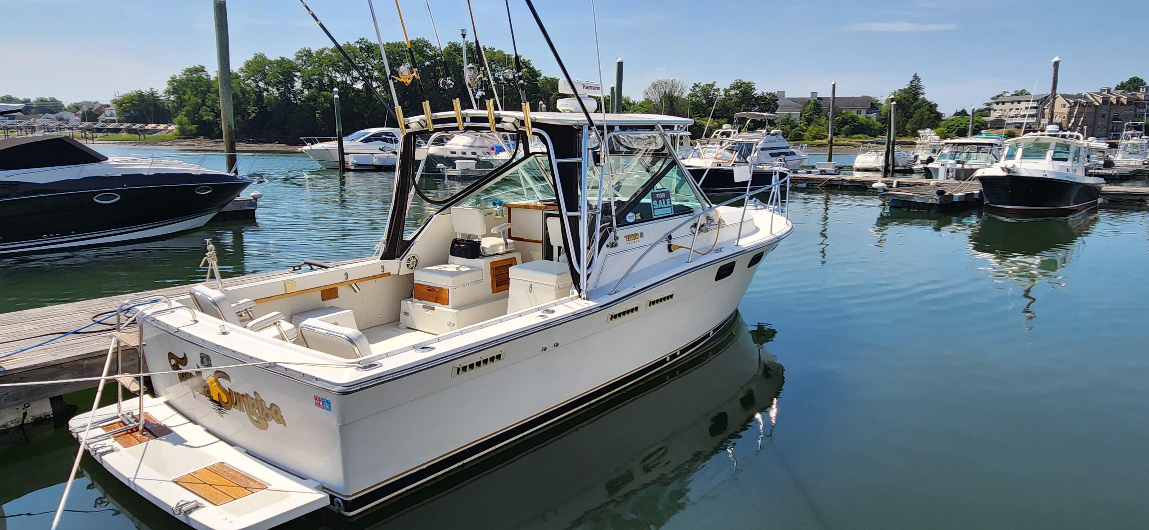 Tiara Yachts 2700 Open 1988 Tiara Yachts 2700 Open boat docked in a marina, surrounded by other boats.