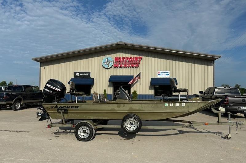 Tracker 1860 Grizzly 2012 Tracker 1860 Grizzly boat on trailer outside dealership, featuring Mercury engine.