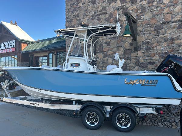 Mako 214 CC 2025 Mako 214 CC boat on trailer, parked outside a stone building.
