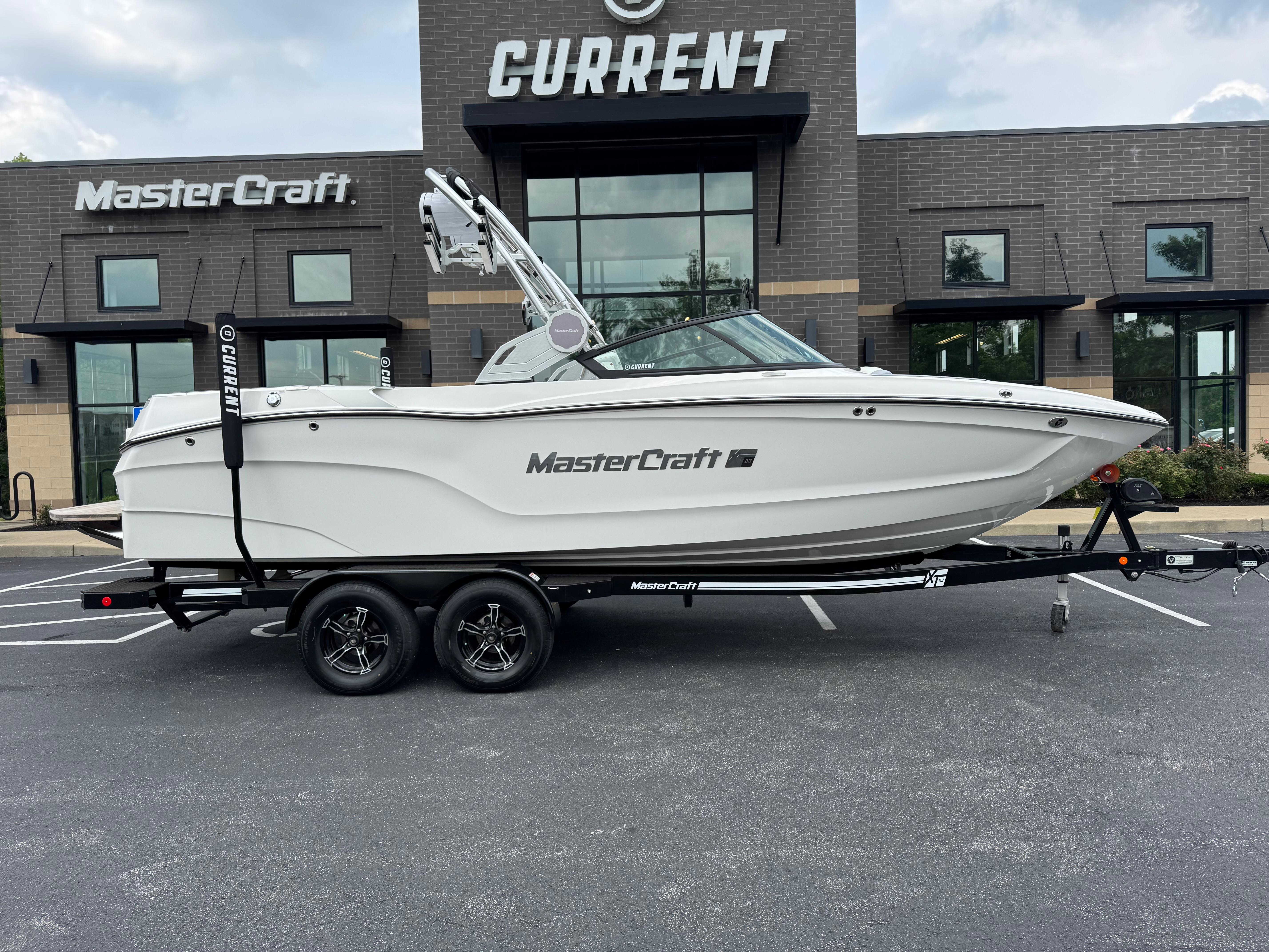MasterCraft XT23 2023 MasterCraft XT23 boat on trailer outside dealership.
