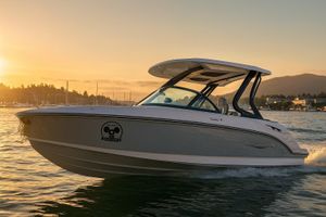 Monterey Elite 25 OB 2026 Monterey Elite 25 OB boat cruising at sunset on a serene lake.