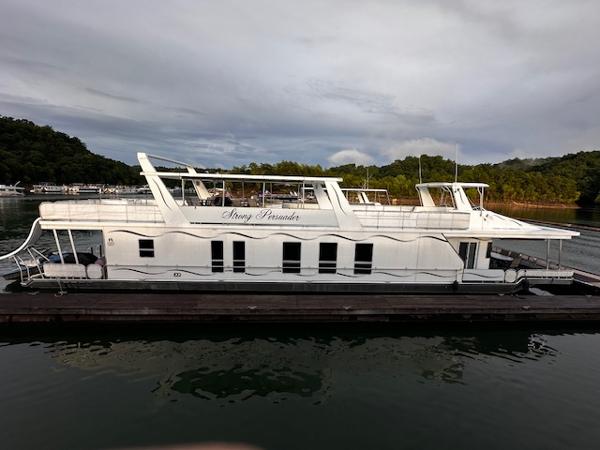 Sharpe 18 x 85 Houseboat 2007 Sharpe 18 x 85 houseboat docked on a serene lake with lush greenery.