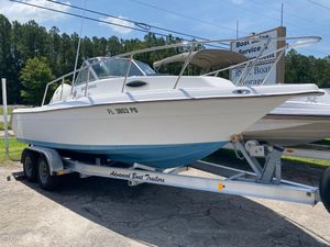 Key West 2020WA Bluewater Key West 2020WA Bluewater 1999 boat on trailer, parked outdoors, sunny day.