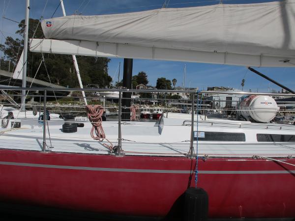 Santa Cruz Santa Cruz 70 1985 Santa Cruz 70 sailboat with red hull docked at marina.
