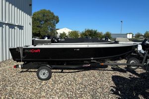 Alumacraft V16 2026 Alumacraft V16 boat on trailer, parked outdoors on gravel.